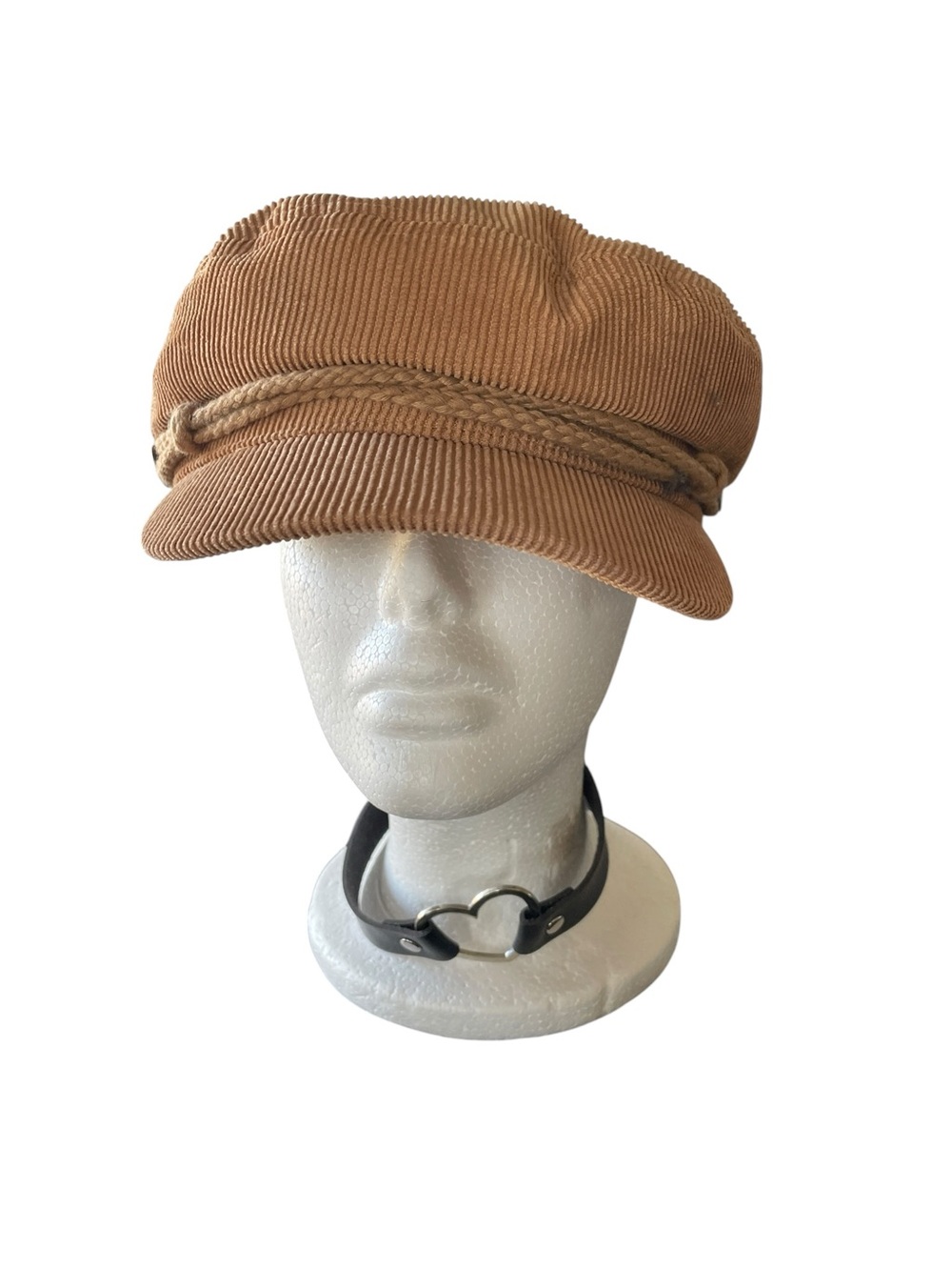 Urban Outfitters a tan corduroy baker boy hat.
